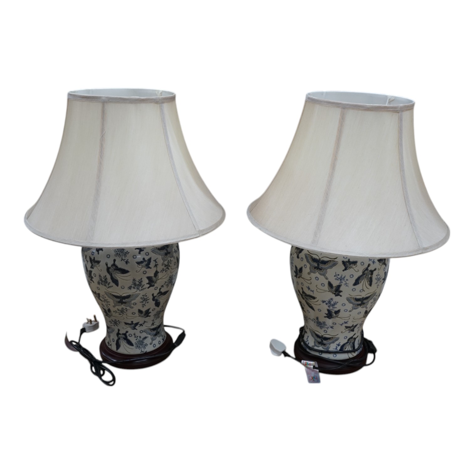 A pair of Japanese ceramic table lamps, decorated with butterflies, with shades. Condition - good, untested